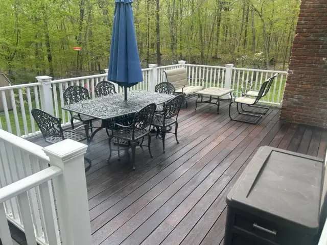 Clean deck boards with dining table, umbrella and seating area