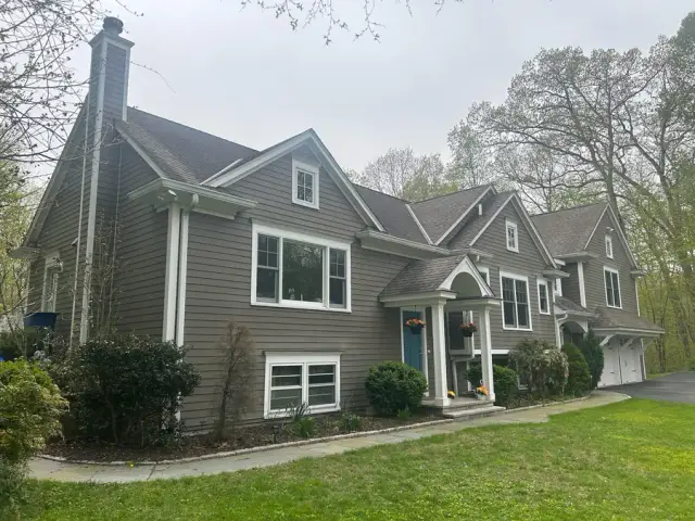 Recently washed house exterior with clean gray siding