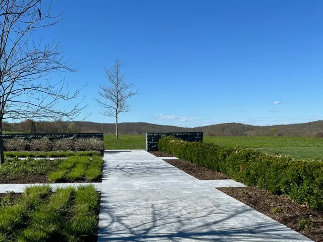 Clean stone walkway through landscaped garden beds